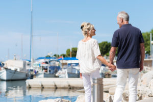 A couple holding hands by a docking area